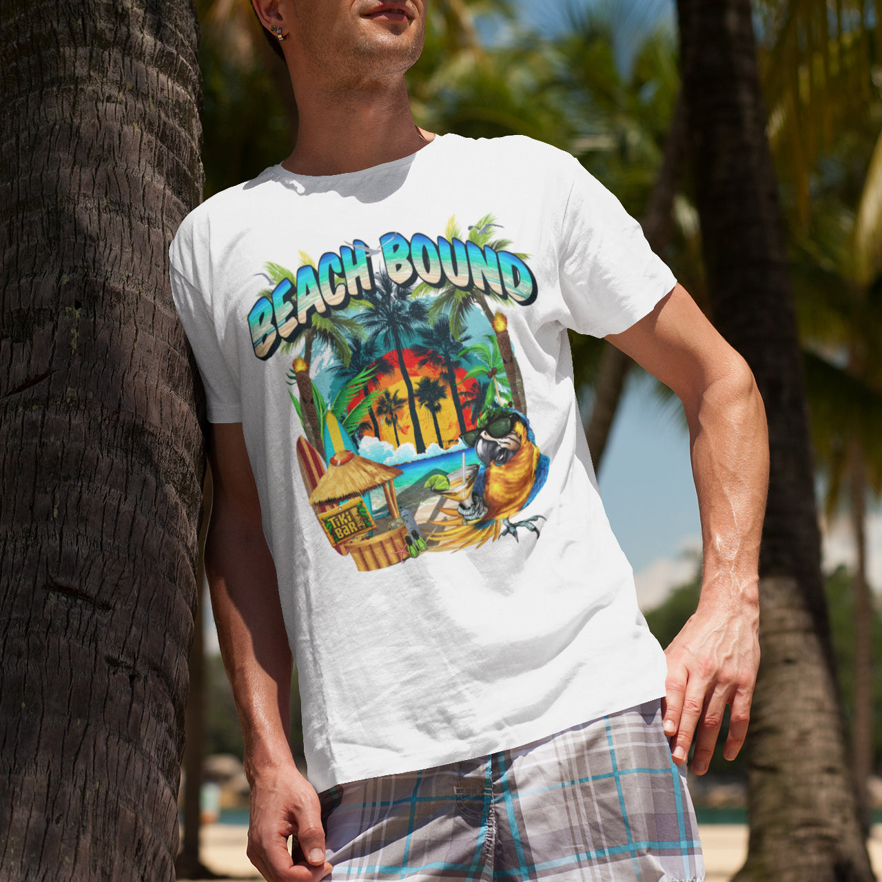 t-shirt-mockup-of-a-man-at-the-beach-leaning-on-a-palm-tree-beach-bound-arczeal-designs